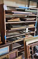 Front view of wooden shelving unit with narrow shelves, contents visible but not included