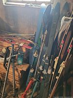 Skis, poles, rack grouped against wall