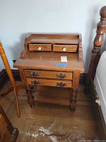 Full view of nightstand between bed and lamp stand