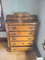 Front view showing four small top drawers and four large lower drawers