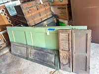 Overall lot showing green door and two narrow shutter panels leaning against wall