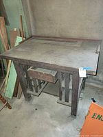 Front view of solid wood workbench showing backsplash and drawer