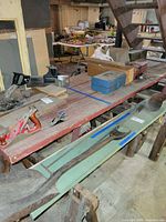 Overall view of red wooden workbench with items on top