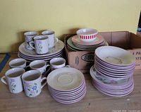 Full lot with mugs, plates, bowl and original box visible