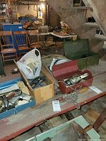 Overview of multiple toolboxes and drill bodies in basement setting