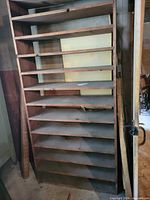 Full front view of tall unfinished plywood shelf with ten levels