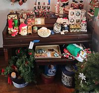 Front view of upright piano with bench beneath, showing overall design and accessories on top (not included)
