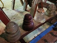 Four insulators in row showing materials and colors