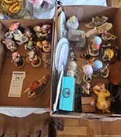 Two boxes filled with assorted Goebel Hummel figurines, animal figurines, plates and trinket boxes