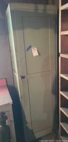 Full front view of green painted cabinet