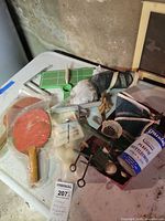 overview of lot showing paddles, shuttlecock tube, net, hardware