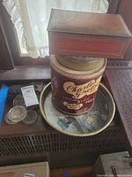 Overall lot showing rectangular tin, cylindrical Charles tin, tray, glass pads and rubber feet