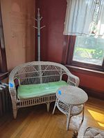 Loveseat with cushion and side table in room