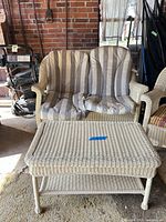 Loveseat front view with cushions and coffee table ottoman in foreground