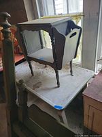 Full view of wood magazine rack table showing side storage slot and lower shelf