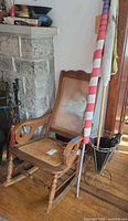 Rocking chair, flag, umbrella stand and umbrella overall view