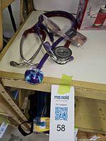 Two stethoscopes with replacement parts pack on shelf