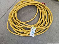 Coiled yellow extension cord overall view