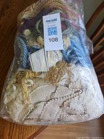 Bag showing assorted trim pieces with Maxsold tag