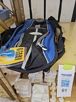 Front view of blue and black CamelBak hydration backpack with attached blue drink tube and packaged bite valve