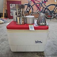 Igloo Marine 25 cooler with stove, pot/case and toast maker placed on lid