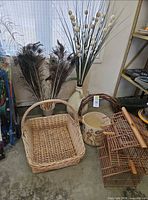Group shot showing feathers, grass sprays in jug, wicker basket, ceramic planter, bamboo birdcage, grapevine wreath