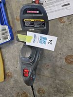 Overall view of Duramaxx hedge trimmer showing handle, trigger, cord inlet and auction tag