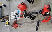 Full trimmer with engine, straight shaft, red guard, accessories laid out