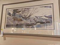 Full view of framed print on wall showing frame, matting, and artwork