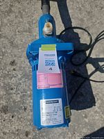 Overall view of blue Mastercraft utility pump with hose and cord