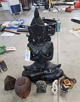 Full lot showing Buddha statue and six smaller pieces