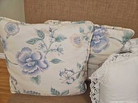 Pastel floral pillows and white crochet pillow