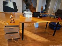 Desk with pedestal underneath left side; shows overall style, colour and leg design