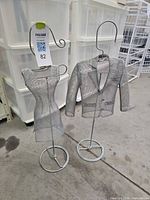 Front view of both silver metal mesh dress and jacket form mannequins on stands