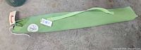Hammock inside green drawstring sleeve with strap and tags visible