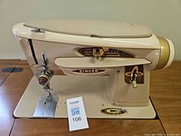 Singer Slant-O-Matic sewing machine on cabinet top