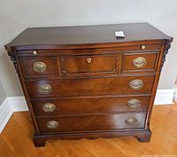 Front view of mahogany dresser showing four drawers and hardware