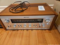 Front view of Sony STR-6045 receiver displaying controls and dial