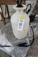 Assembled sprayer showing tank, hose and handle