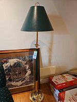 Full view of brass floor lamp with green shade
