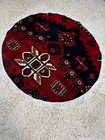 Full view of round Bakhtiyar rug showing design and fringe