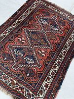 Full view of Shiraz wool rug showing entire design and borders