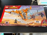 Front of LEGO Marvel Super Heroes Avengers Infinity War 76107 box showing Benatar spaceship, Thanos, Iron Man, Gamora, Infinity Gauntlet stand