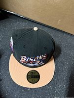 Top view of New Era Buffalo Bisons fitted hat showing crown, brim, front logo and size sticker