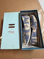 Shoes in branded box showing collaboration logo