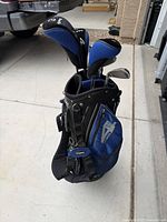 Blue and black stand golf bag loaded with clubs