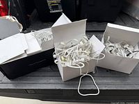 Three open boxes with coiled white Govee light strings on truck tailgate