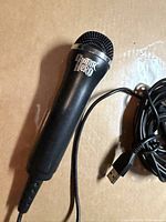 Full view of Guitar Hero microphone with USB cable