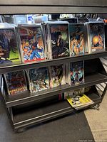 Front view of two shelves filled with bagged comic books on rolling cart