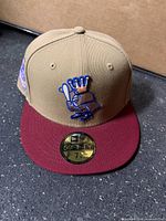 Front view of hat showing logo and brim sticker